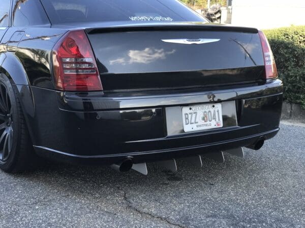 The back of a black car parked in a driveway