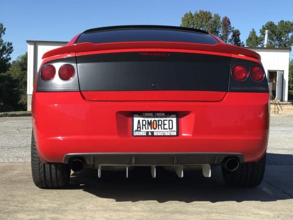 A red sports car parked in a driveway