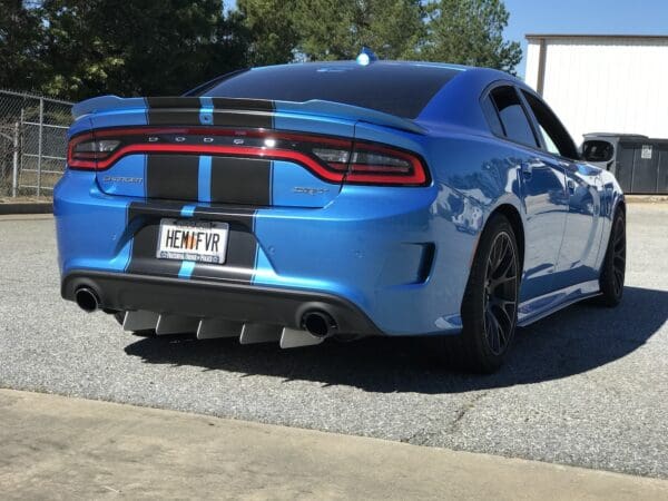 A blue dodge charger parked in a parking lot