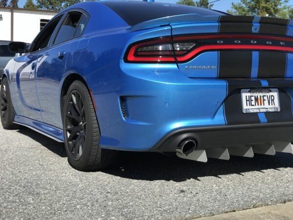 A blue dodge charger parked in a parking lot