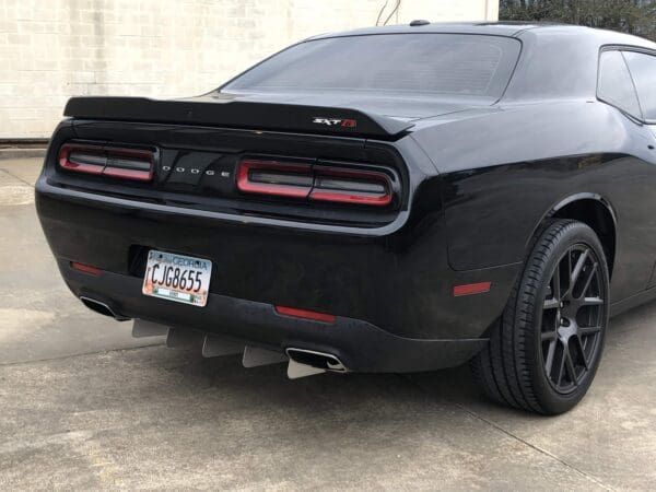 A black sports car parked in a driveway