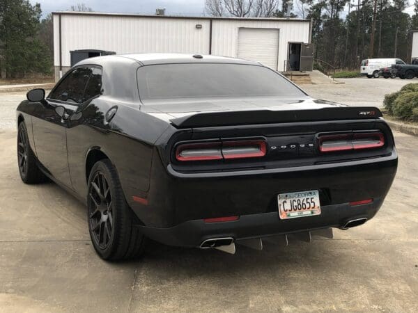 A black sports car parked in a parking lot