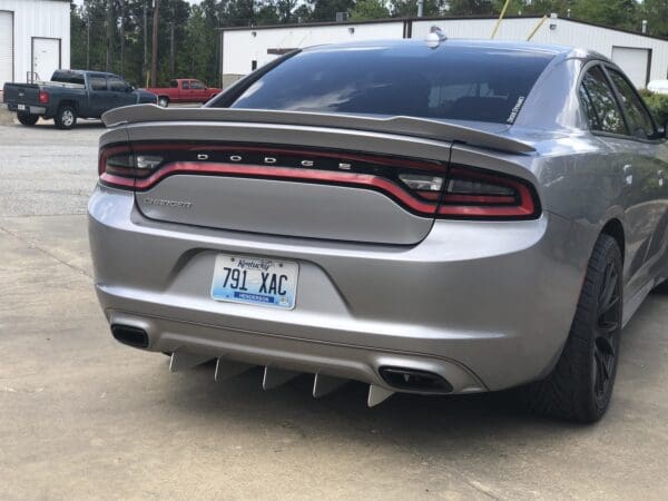 A silver dodge charger parked in a parking lot