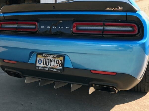 The rear end of a blue and black sports car