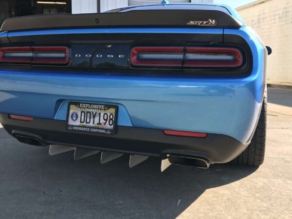 The rear end of a blue Dodge sports car with an SRT badge and license plate DDY198.