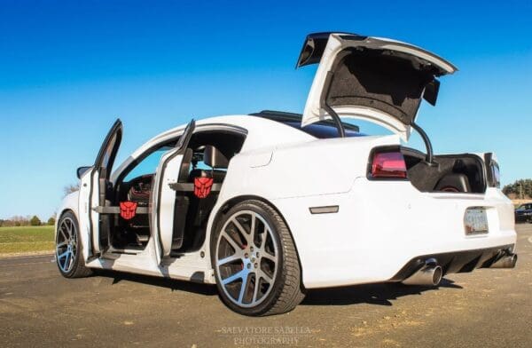 A white sports car with its doors open