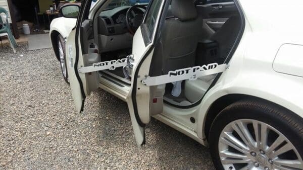 A white car with its door open and the door open