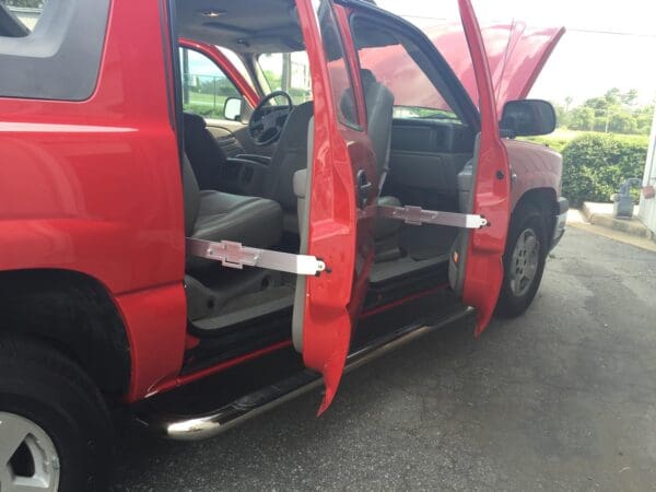 A red pick up truck with its doors open