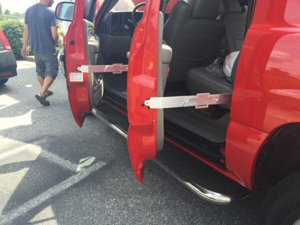 A red van with its doors open and a man walking by