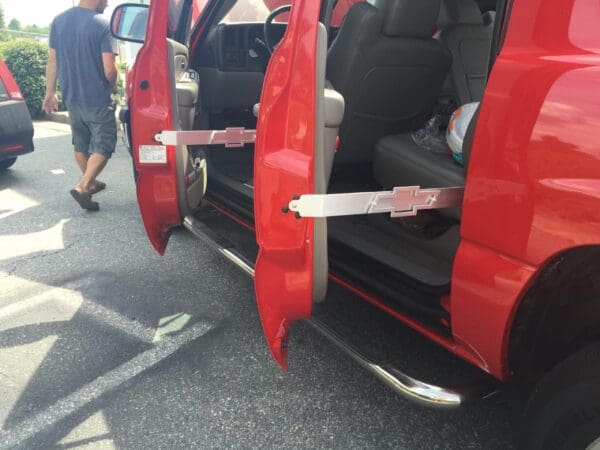 A red van with its doors open and a man walking by