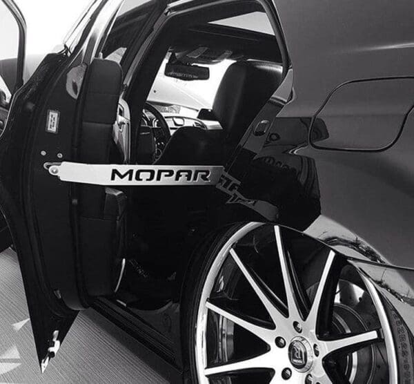 A black and white photo of a car with its door open