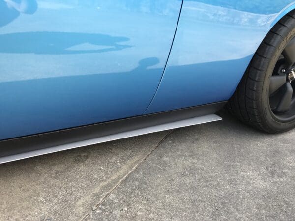 A blue car parked on the side of the road