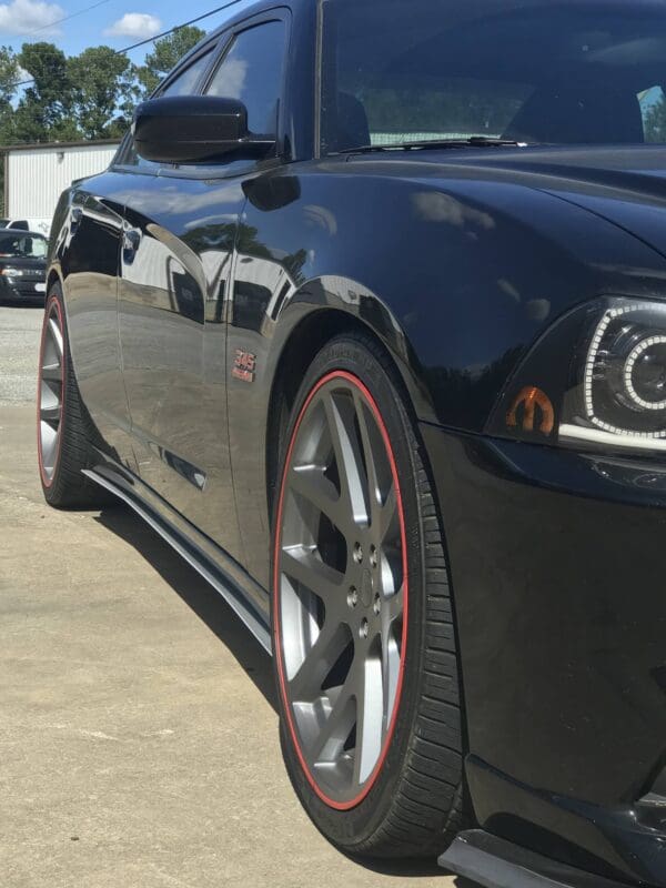 A black sports car parked in a parking lot