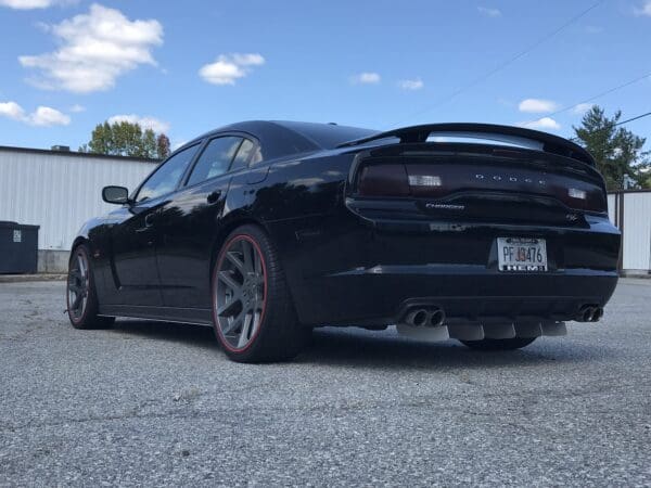 A black car parked in a parking lot