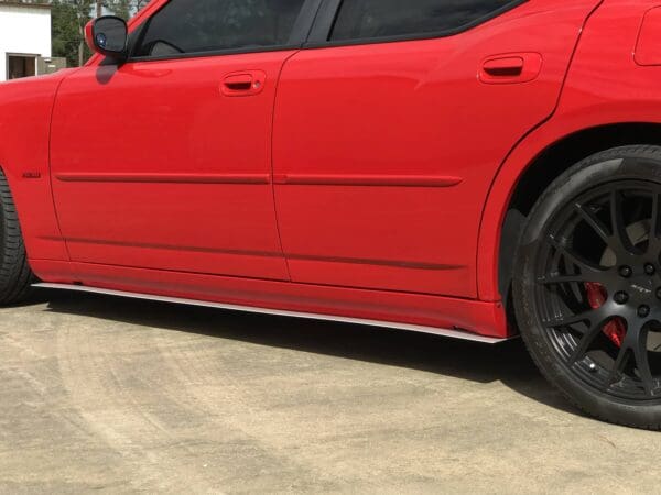 A red sports car parked in a parking lot