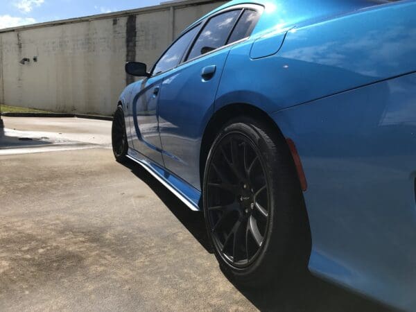 A blue sports car parked in a parking lot