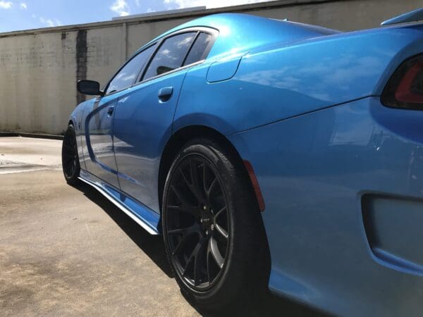 A blue sports car parked in a parking lot