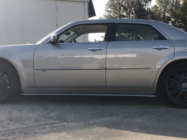 A silver car parked in front of a building