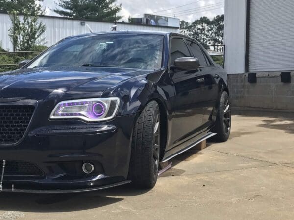 A black car parked in front of a building