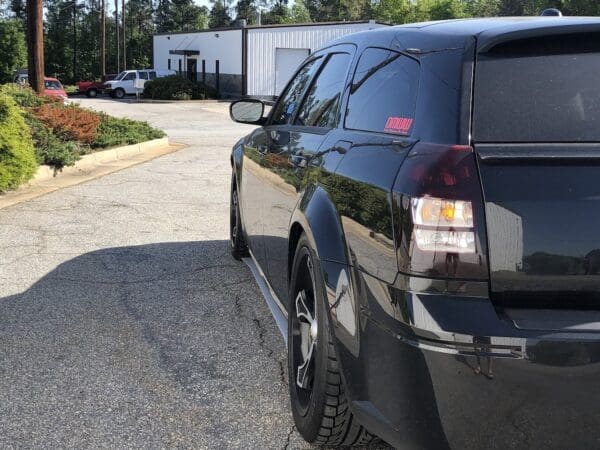 A black car parked in front of a building