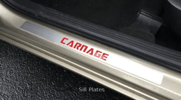 The word CARNAGE engraved on a car door