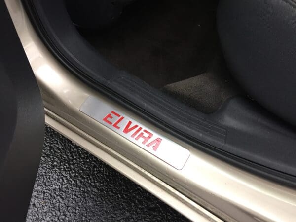 The word ELVIRA engraved on a car door