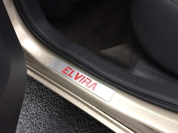 ELVIRA engraved on a car door sill plate.