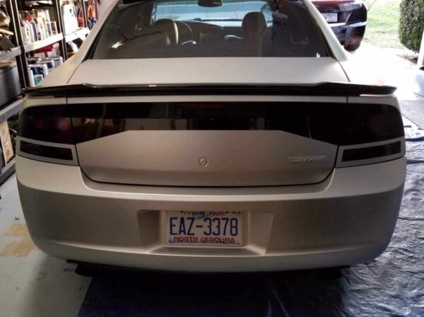 A silver car is parked in a garage