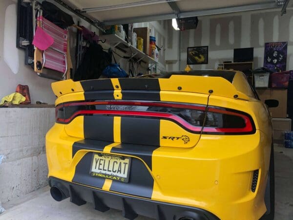 A yellow sports car parked in a garage