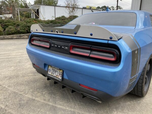 The rear end of a blue sports car