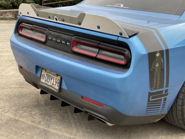 The rear end of a blue sports car