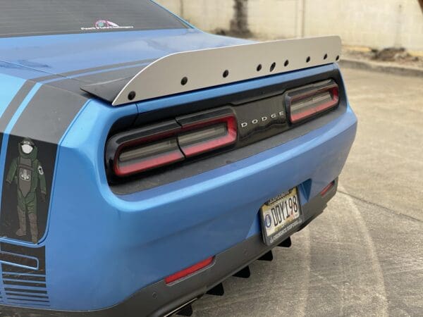 The rear end of a blue sports car