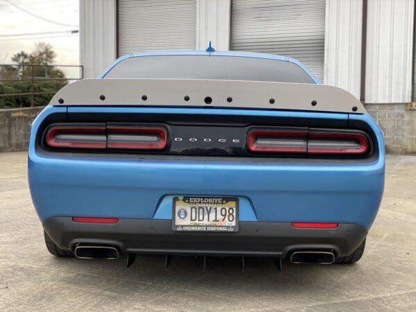 The rear end of a blue sports car