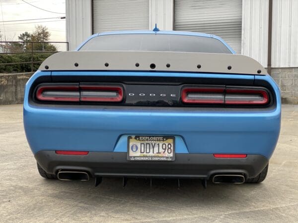 The rear end of a blue sports car