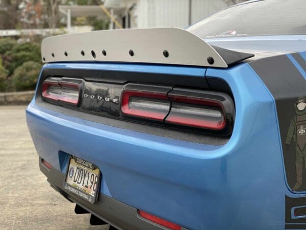 The rear end of a blue sports car