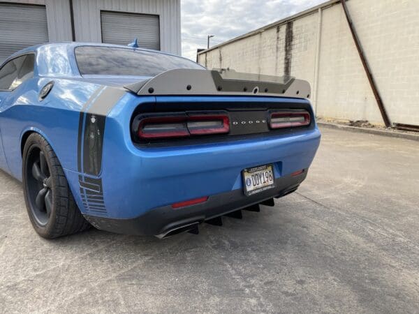 A blue car parked in front of a garage