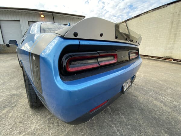 The rear end of a blue sports car