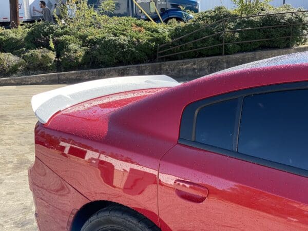 A red car parked in a parking lot