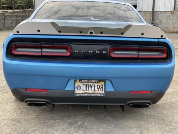 The rear end of a blue sports car