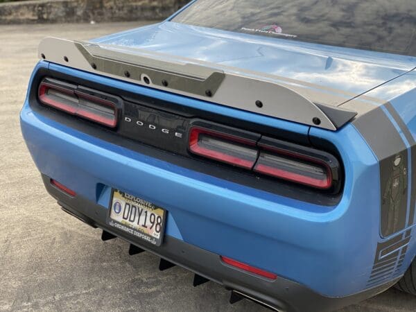 The rear end of a blue sports car