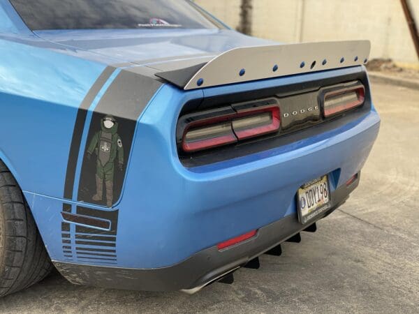 The rear end of a blue sports car