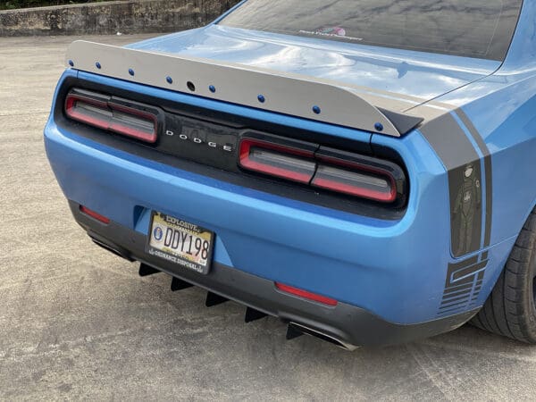 The rear end of a blue sports car