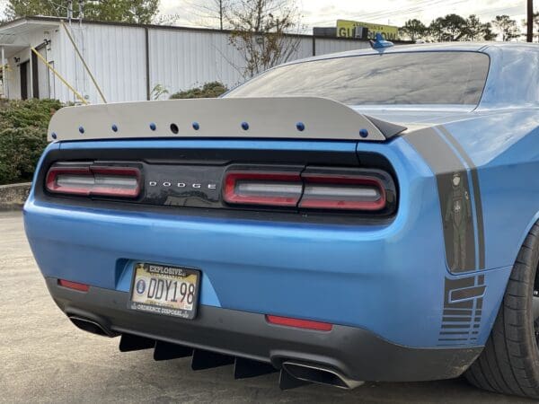 The rear end of a blue sports car