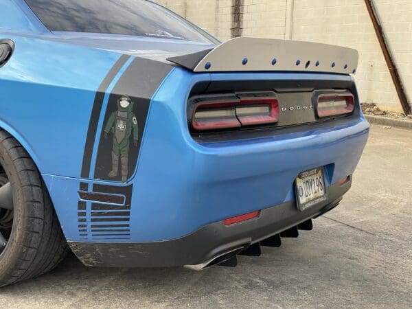 A blue car parked in a parking lot