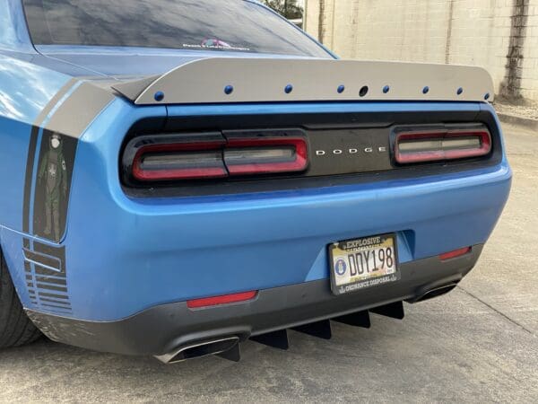 The rear end of a blue sports car