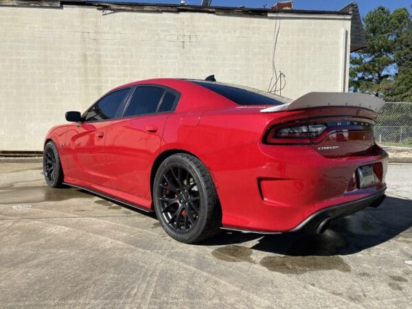 A red sports car parked in a parking lot