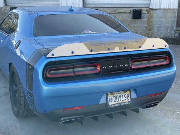 A blue car parked in front of a garage