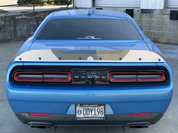 A blue car parked in a parking lot