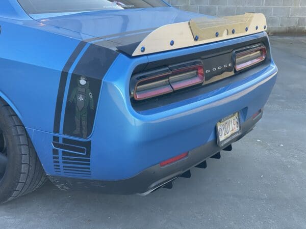 The rear end of a blue sports car