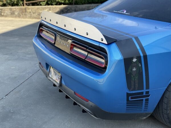 A blue sports car parked in a driveway